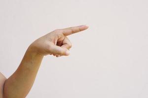 Asian woman's hand pointing forward photo
