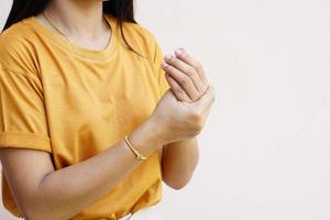 Woman holding her wrist pain from using computer, office syndrome photo