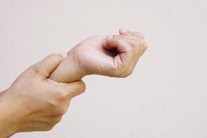 Woman holding her wrist pain from using computer, office syndrome photo