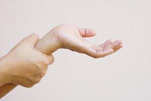 Woman holding her wrist pain from using computer, office syndrome photo