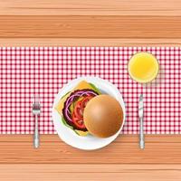 Fast food with fork and knife on wooden table