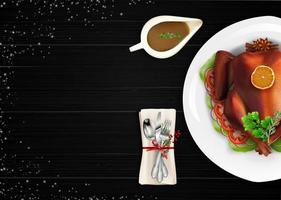 Roasted turkey bird on white plate with spoon, fork and knife on dark wooden table