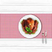 Roasted turkey bird on white plate with fork and knife on white wooden table vector