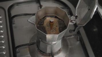 The assembly process and brewing fresh coffee with MOKA POT. Make fresh coffee on the gas stove in the kitchen at home.