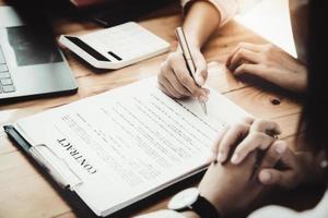 Business owner holding a pen to read the conditions to enter into a joint venture contract with a partner company. photo