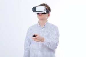 Young business man in vr glasses, goggles watching virtual reality isolated on white background. Copy space and mock up photo