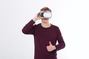 Young man in virtual reality glasses isolated on white background and big thumb up. Vr concept. Template and blank shirt. Copy space and mock up photo