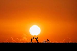 Two children are throwing balls in the meadow happily. Children's happiness concept photo