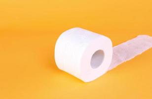 Roll of toilet paper on a orange background