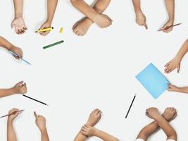 Back to school concept. Set of pupil hands. Top view photo