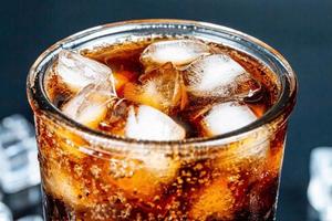 Glass of cola with ice, closeup photo
