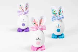 Easter eggs decorated like rabbits with ears. Holiday background photo