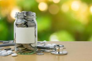 Money bottle with coins on bokeh background photo