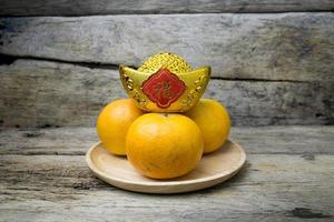 Mandarin oranges with decorative gold nugget photo