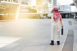 Arab businessman check graph on smartphone, finance concept photo