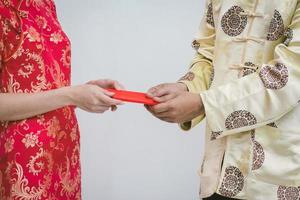 Asian couple holding red Chinese new years envelopes. Chinese new year. photo