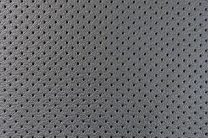 leather texture with small black holes, abstract background photo