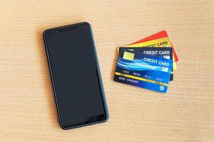 credit card and smartphone on table. On-line shopping on the internet using a smartphone photo