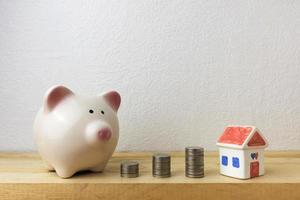 piggy bank with house and coins photo