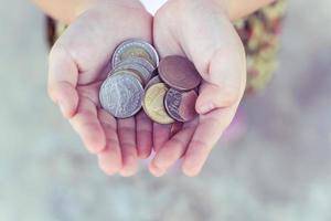 Coin in children hand. Business and finance concept photo