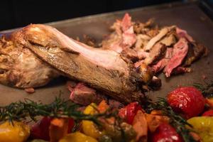 grilled goat with vegetables and spices on a cutting Board photo