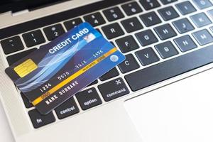 Credit card on a computer keyboard. internet purchase concept photo