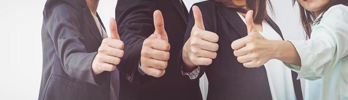 Successful business people with thumbs up, business team photo