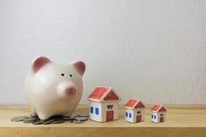 piggy bank with house and coins photo