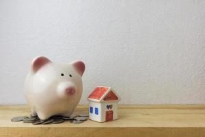 piggy bank with house and coins photo