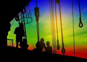 Silhouettes of workers at a construction site photo