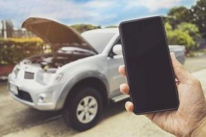 Man Phoning For Help with a broken down car photo