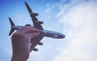 Small kid hands holding airplane photo