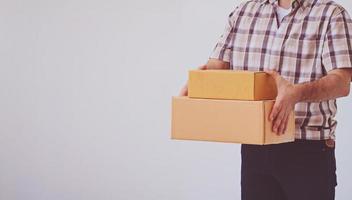 Asian young man holding box package, delivery man photo