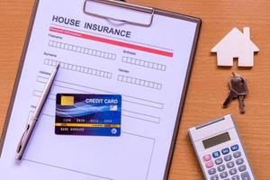 House insurance form with model and policy document photo