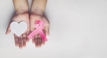 Child holding pink ribbon. breast cancer awareness photo