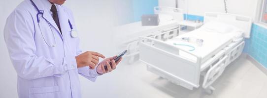 young doctor man wearing a white coat using a smartphone photo