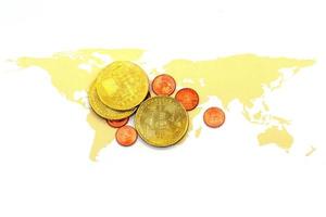 Bitcoin on world map and on white background. photo