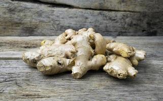 Ginger on grunge wooden background photo