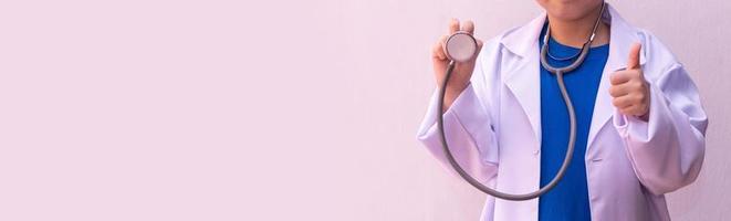 Asian girl playing doctor with stethoscope in hands. photo