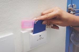Asian women hand hold card for door access control scanning key card to lock and unlock door. photo