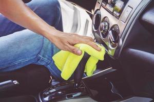 man cleaning car with microfiber cloth photo