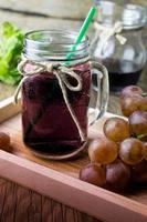 Fresh and juice grapes on wooden table photo
