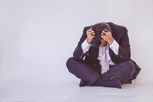 Depressed businessman sitting on the floor photo