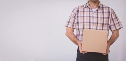 Asian young man holding box package, delivery man photo