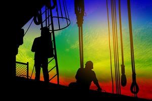 Silhouettes of workers at a construction site photo