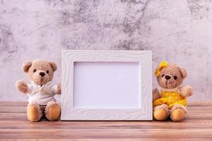 couple teddy bear with Picture frame on table wooden. Valentine's Day celebration photo
