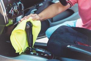 man cleaning car with microfiber cloth photo