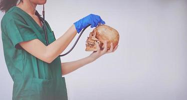 doctor are checking skull of human head photo