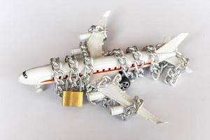 Airplane with chain and padlock, Safety concept. photo