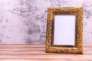 Picture frame on wall background and wooden table. Poster product design styled photo
